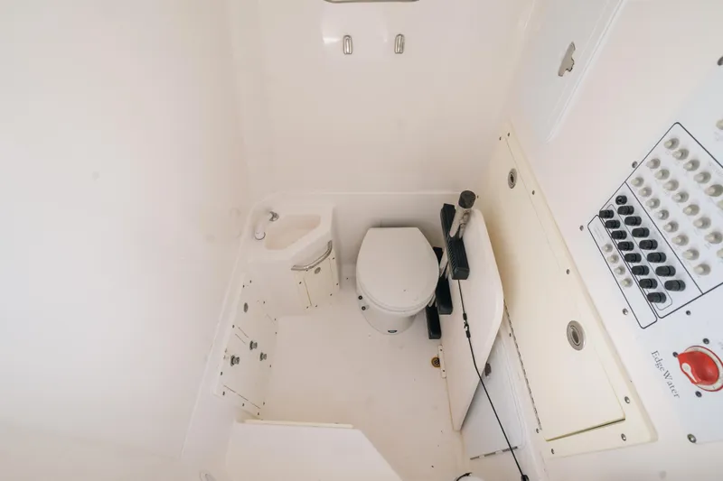 Slide: The Image of 2017 Edgewater 318CC boat interior with toilet and control panel. - 7