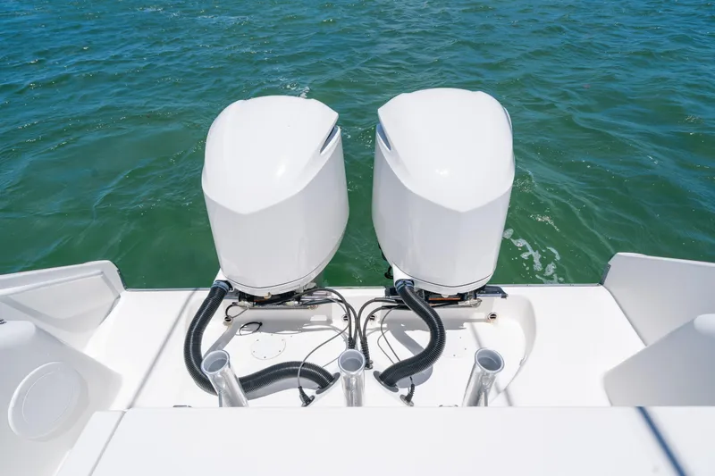 Slide: The Image of 2017 Edgewater 318CC boat with dual outboard engines on open water. - 8