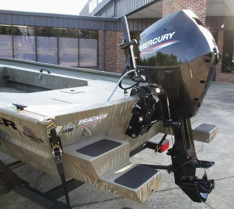 Slide: The Image of 2025 Tracker GRIZZLY® 1654 T Sportsman boat with Mercury outboard motor, camo design. - 5