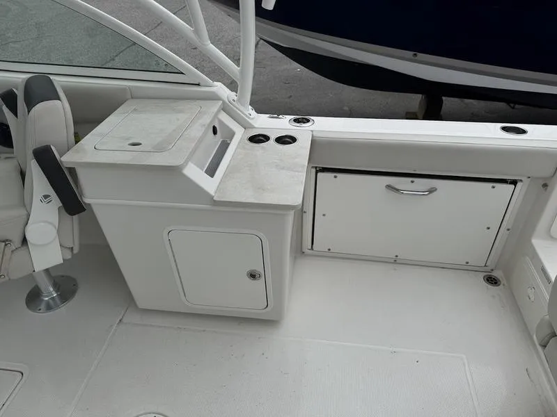 Slide: The Image of 2023 Sailfish 245 DC boat interior with seating and storage compartments. - 10