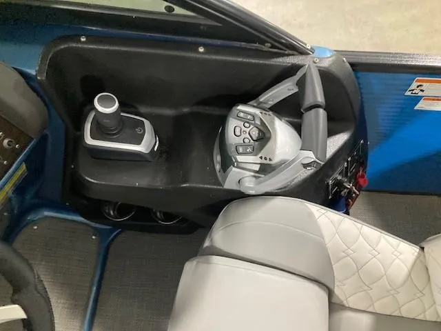 Slide: The Image of 2019 Manitou 25 Legacy LT RFXW boat steering console with joystick and controls. - 3