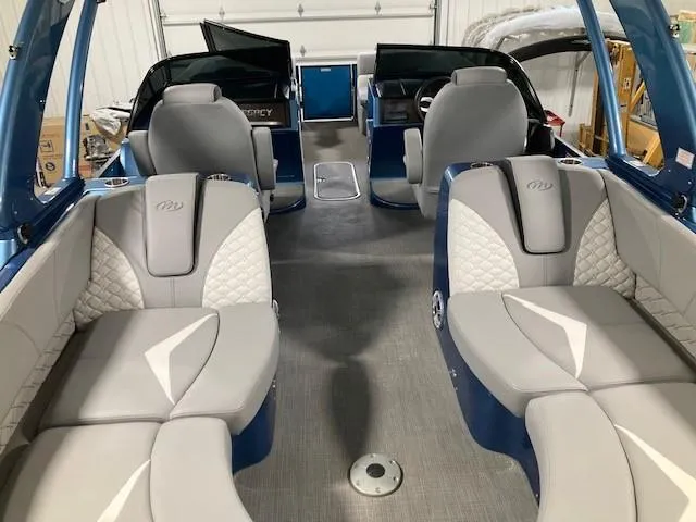 Slide: The Image of 2019 Manitou 25 Legacy LT RFXW boat interior with luxurious seating and modern design. - 8