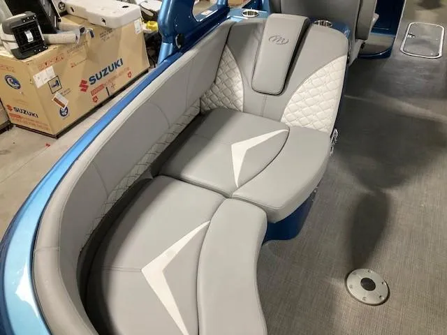 Slide: The Image of 2019 Manitou 25 Legacy LT RFXW boat interior with gray cushioned seating. - 9