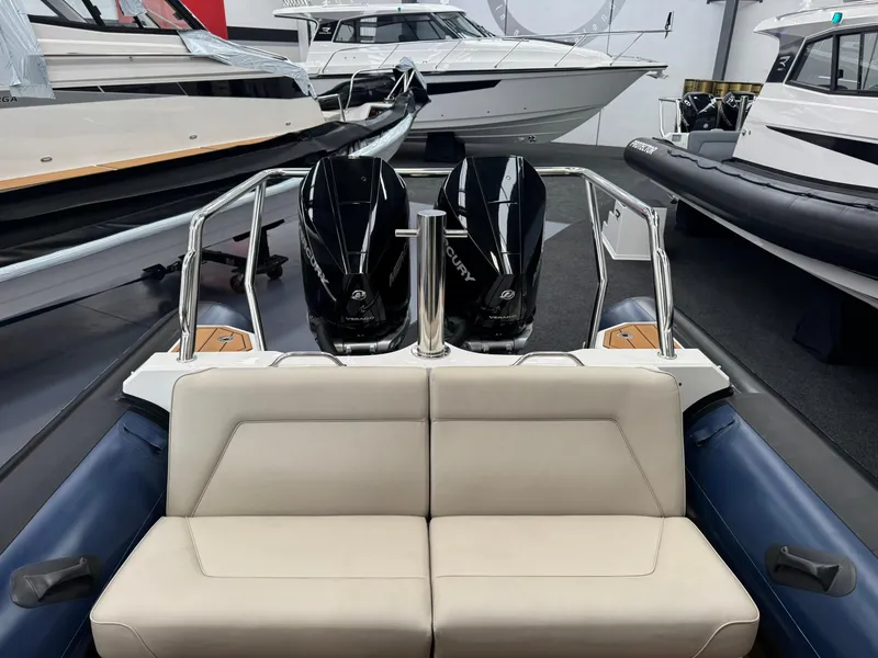 Slide: The Image of 2025 Protector 310 Targa boat with dual Mercury V8 300 HP engines in showroom. - 21