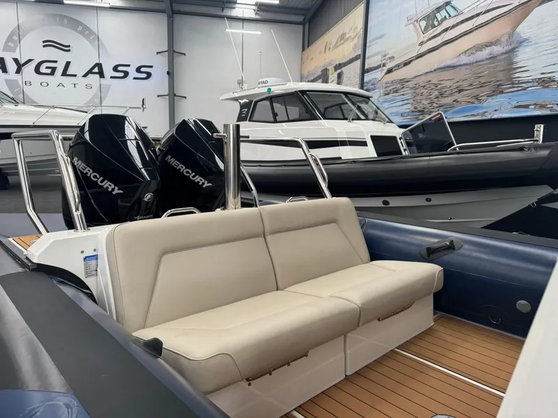 Slide: The Image of 2025 Protector 310 Targa boat with dual Mercury engines in showroom. - 23