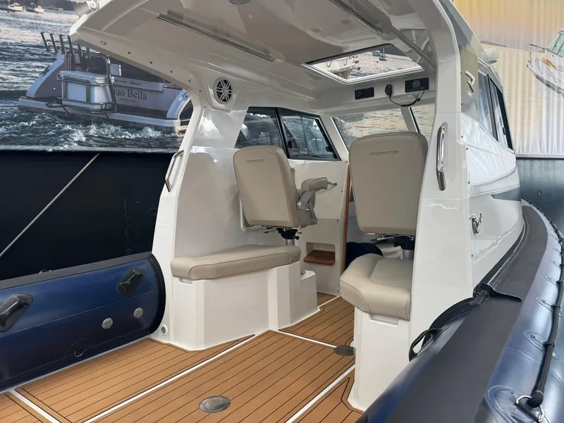 Slide: The Image of Interior of 2025 Protector 310 Targa boat with seating and modern design. - 7