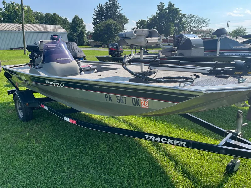 Slide: The Image of 2013 Tracker Pro 170 boat on trailer, parked on grass, with clear sky background. - 3