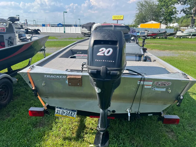 Slide: The Image of 2013 Tracker Pro 170 boat with 20HP FourStroke engine, parked on grass. - 8