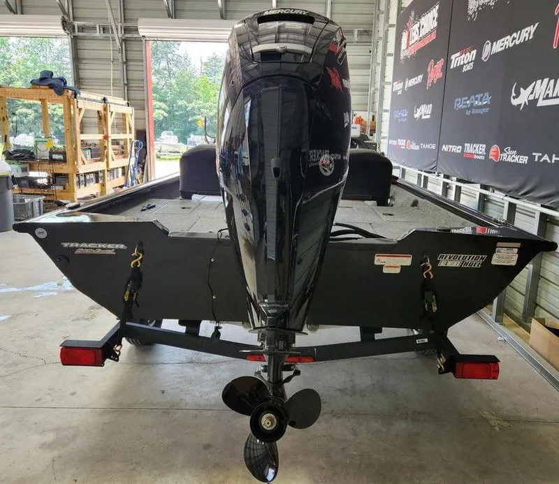Slide: The Image of 2026 Tracker Pro Team™ 175 boat with Mercury outboard motor in a garage. - 5