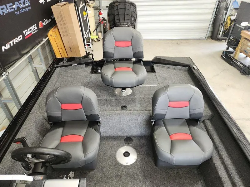 Slide: The Image of 2026 Tracker Pro Team™ 175 boat interior with four gray and red seats. - 6
