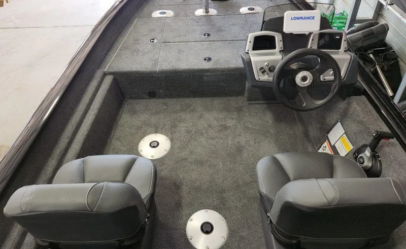 Slide: The Image of 2026 Tracker Pro Team™ 175 boat interior with steering console and seating. - 7
