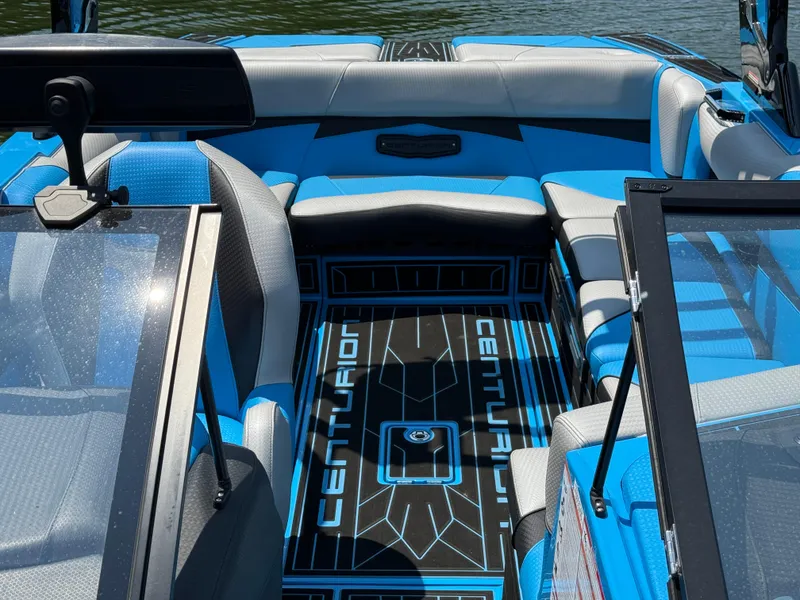 Slide: The Image of 2022 Centurion Fi23 boat interior with blue and gray seating, sleek design, and modern features. - 18