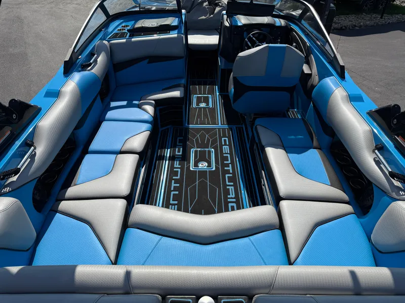 Slide: The Image of 2022 Centurion Fi23 boat interior with blue and gray seating, sleek design. - 8