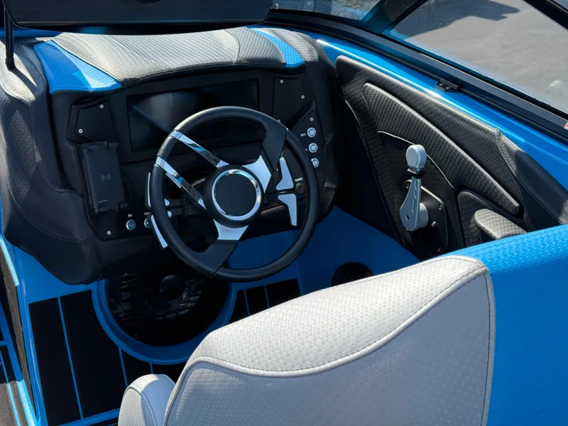 Slide: The Image of 2022 Centurion Fi23 boat cockpit with modern steering wheel and controls, featuring blue and black accents. - 9