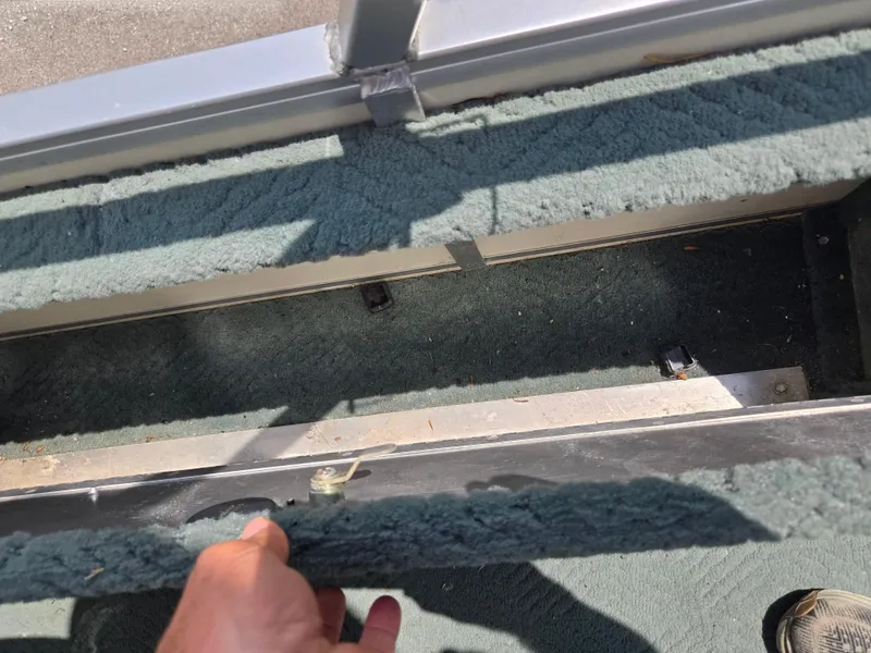 Slide: The Image of 2006 Sun Tracker FISHIN' BARGE 21 interior detail with green carpet and metal frame. - 21