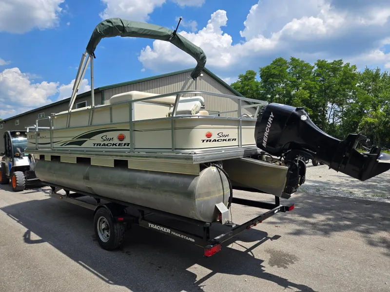 Slide: The Image of 2006 Sun Tracker FISHIN' BARGE 21 Signature Series on trailer, with Mercury outboard motor. - 3