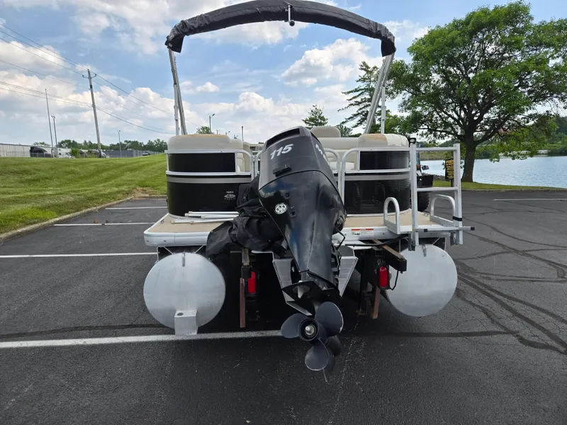 Slide: The Image of 2012 Sweetwater 2486 pontoon boat with 115 HP motor in parking lot. - 2