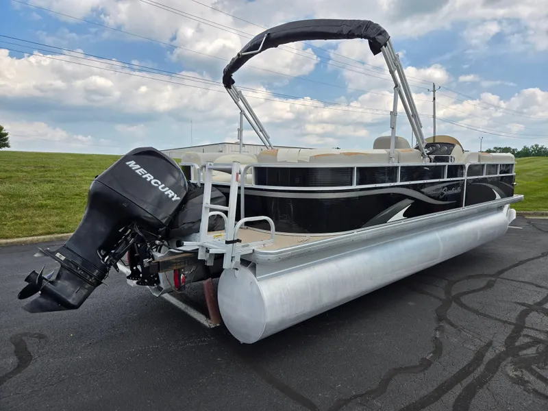 Slide: The Image of 2012 Sweetwater 2486 pontoon boat with Mercury outboard motor on paved surface. - 3
