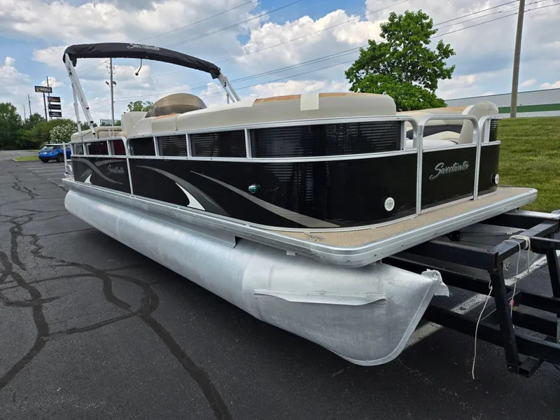Slide: The Image of 2012 Sweetwater 2486 pontoon boat on trailer, black exterior, parked on asphalt. - 5