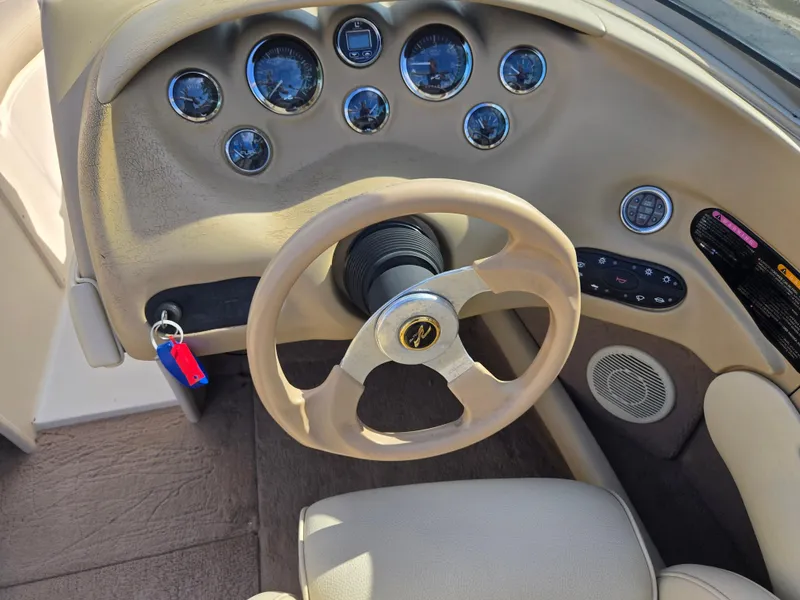 Slide: The Image of 1999 Sea Ray 210 BR boat dashboard with steering wheel and instrument panel. - 14