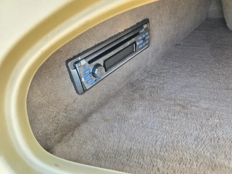 Slide: The Image of 1999 Sea Ray 210 BR interior with built-in stereo system. - 16