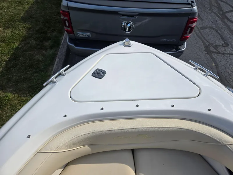 Slide: The Image of Bow of 1999 Sea Ray 210 BR boat parked near a gray truck. - 20