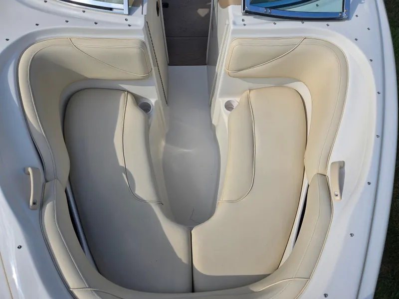 Slide: The Image of 1999 Sea Ray 210 BR boat interior with beige seating and cup holders. - 21