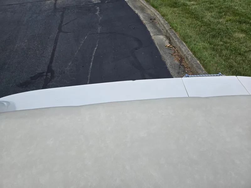 Slide: The Image of Rear view of a 1999 Sea Ray 210 BR boat parked on a street. - 27