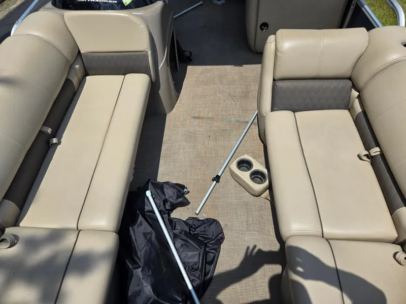 Slide: The Image of Interior of 2022 Sun Tracker Party Barge 20 DLX with beige seating and cup holders. - 11