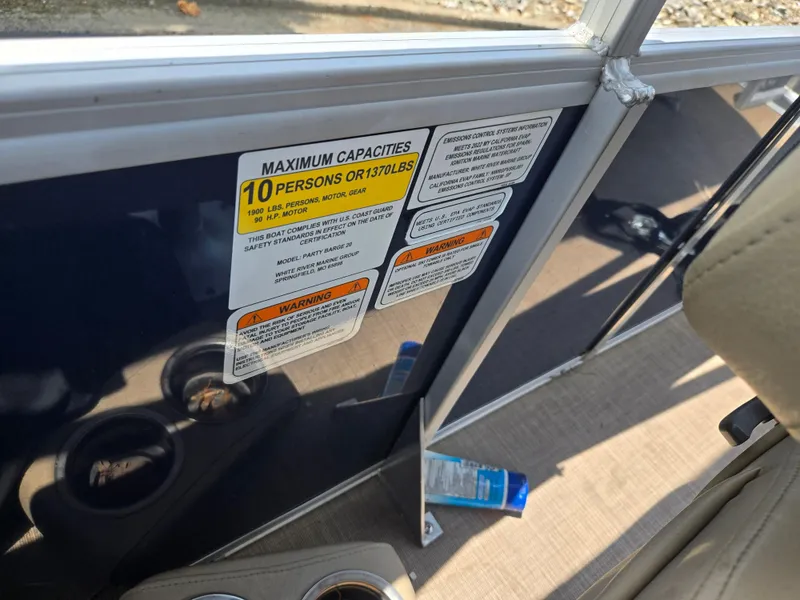 Slide: The Image of 2022 Sun Tracker Party Barge 20 DLX capacity label, showing 10-person limit and safety warnings. - 17
