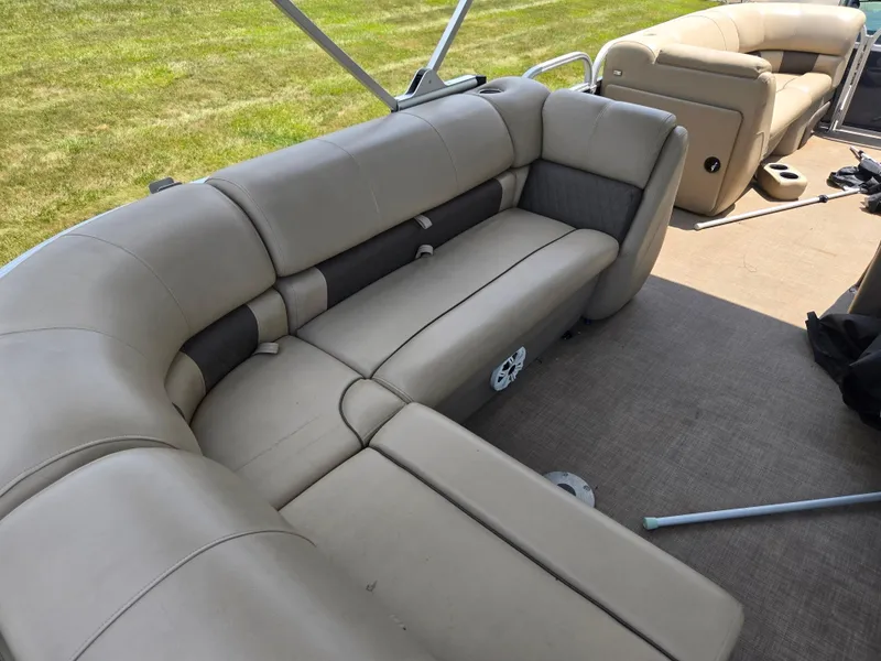 Slide: The Image of 2022 Sun Tracker Party Barge 20 DLX interior with beige seating and spacious layout. - 19