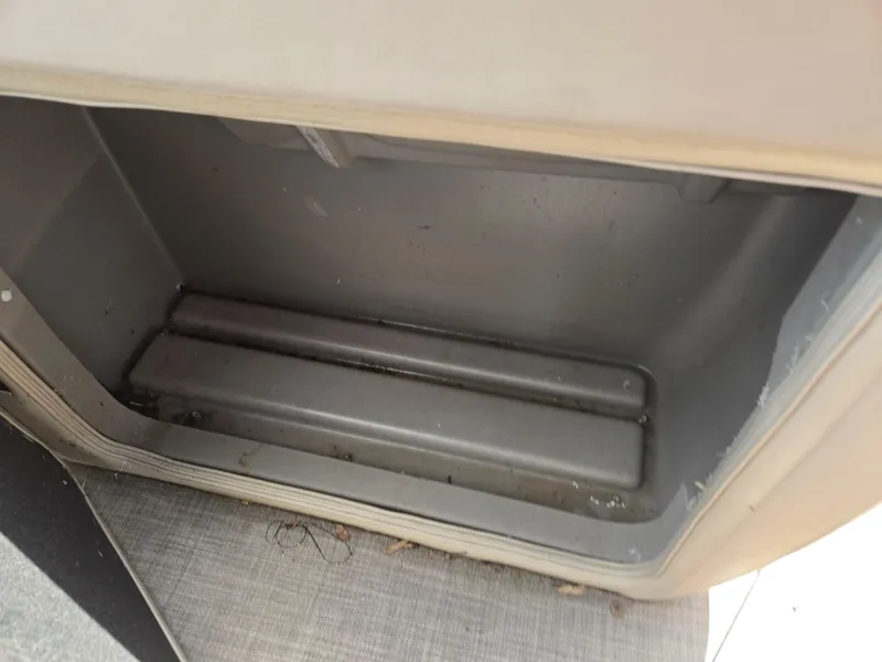 Slide: The Image of Storage compartment of 2022 Sun Tracker Party Barge 20 DLX, partially filled with water. - 23