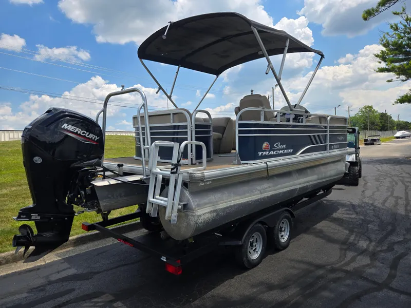 Slide: The Image of 2022 Sun Tracker Party Barge 20 DLX pontoon boat with Mercury outboard motor on trailer. - 3