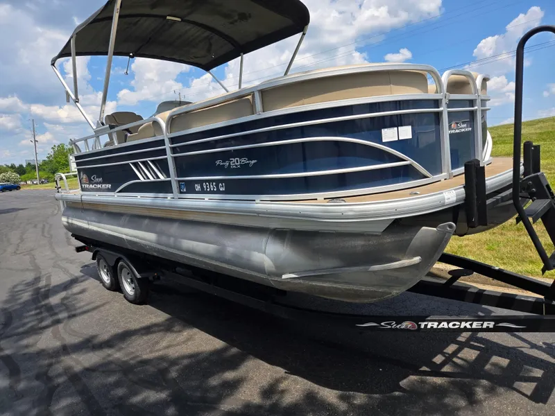 Slide: The Image of 2022 Sun Tracker Party Barge 20 DLX pontoon boat on trailer under blue sky. - 5