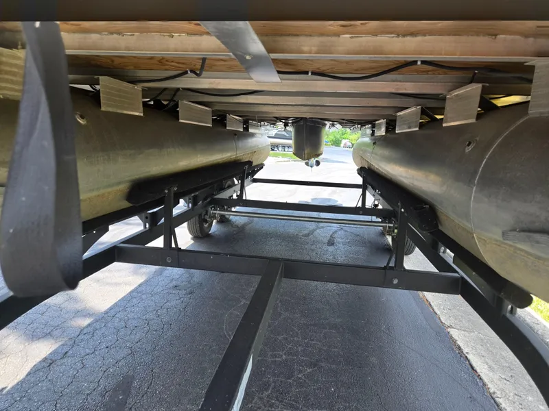 Slide: The Image of Underneath view of 2022 Sun Tracker Party Barge 20 DLX pontoon boat on trailer. - 7