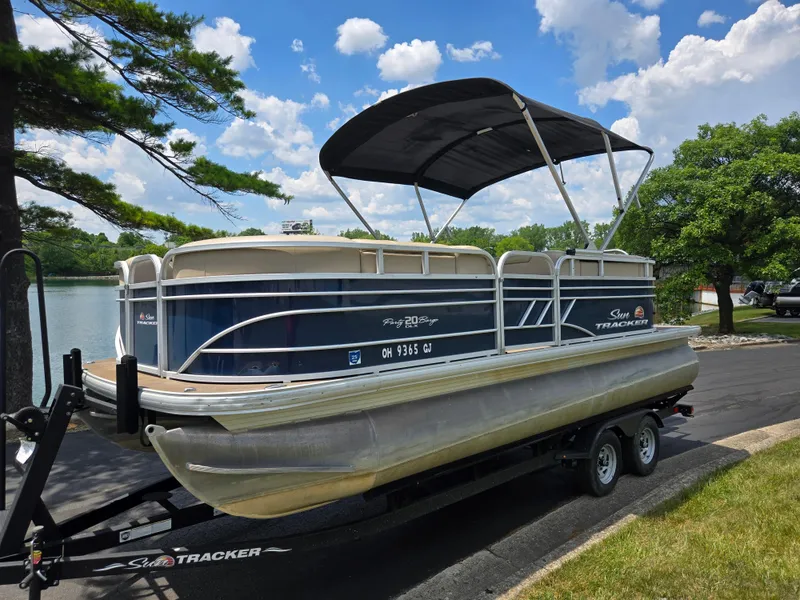 Slide: The Image of 2022 Sun Tracker Party Barge 20 DLX pontoon boat on trailer by a lake. - 8