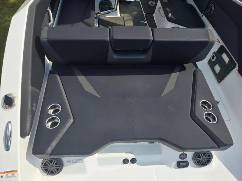 Slide: The Image of 2021 Scarab 285 ID boat interior with cushioned seating and cup holders. - 10
