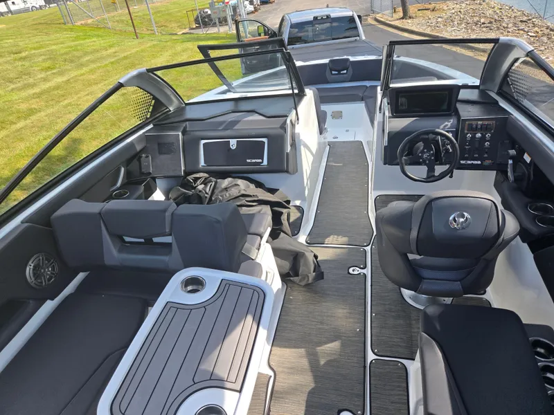 Slide: The Image of 2021 Scarab 285 ID boat interior with seating, steering wheel, and dashboard. - 13