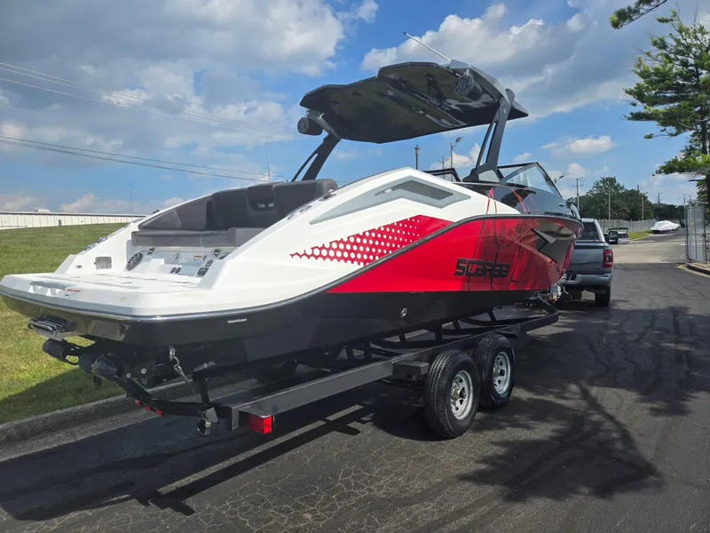 Slide: The Image of 2021 Scarab 285 ID boat on trailer, red and white design, parked outdoors. - 3