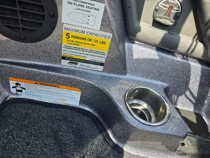 Slide: The Image of 2018 Ranger Z520 Comanche interior with capacity and safety warnings, cup holder, and control panel. - 12