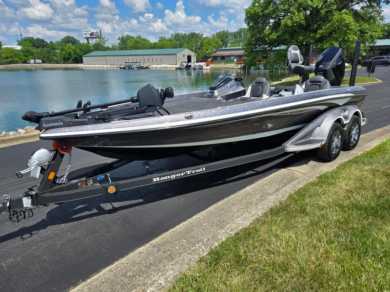 Slide: The Image of 2018 Ranger Z520 Comanche Ranger Cup boat on trailer by a lake under blue sky. - 8