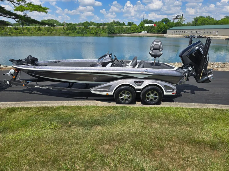Slide: The Image of 2018 Ranger Z520 Comanche Ranger Cup boat on trailer by a lake. - 9