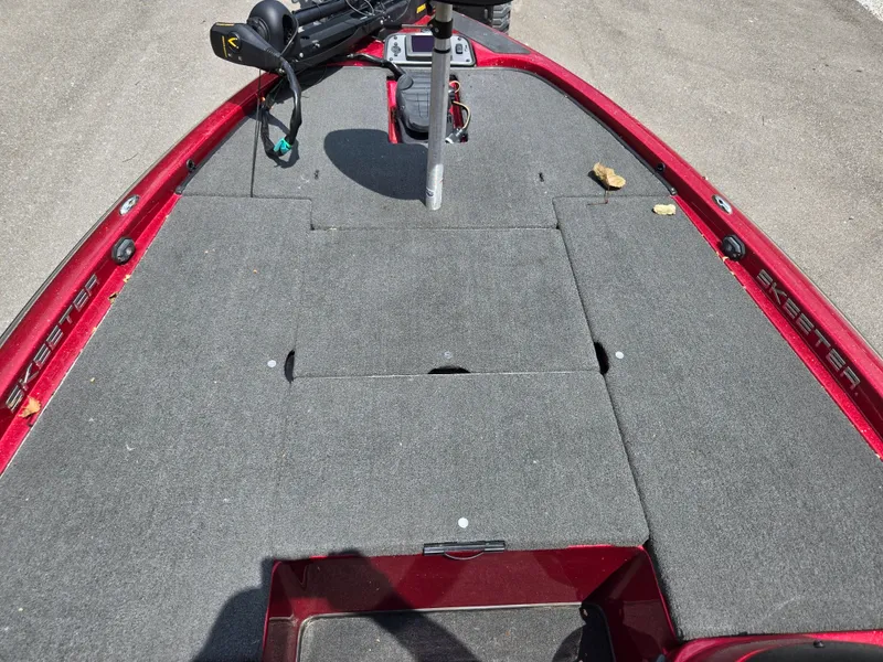 Slide: The Image of 2017 Skeeter TZX 190 boat deck with red trim and gray carpet. - 14