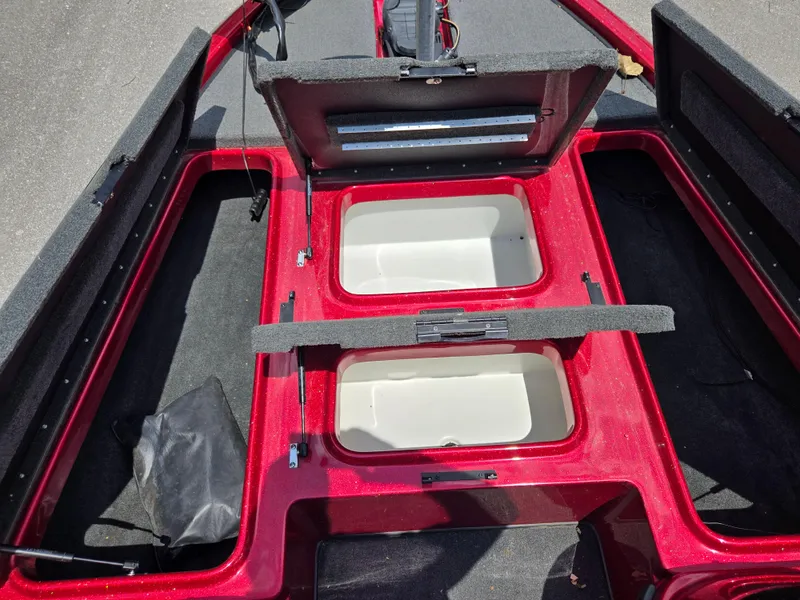 Slide: The Image of 2017 Skeeter TZX 190 boat interior with open storage compartments, red finish, and black carpet. - 15
