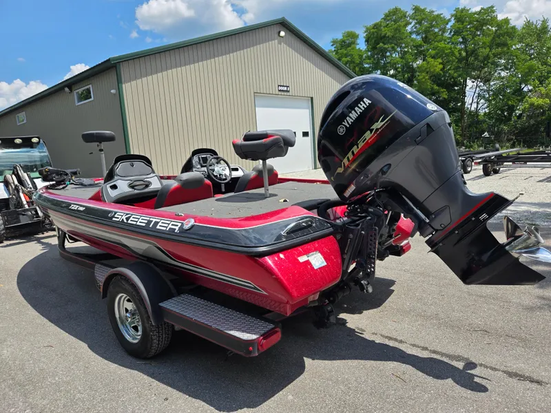 Slide: The Image of 2017 Skeeter TZX 190 boat with Yamaha engine, parked outdoors near a building. - 3