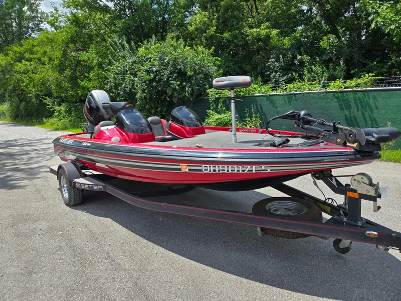 Slide: The Image of 2017 Skeeter TZX 190 boat on trailer, parked on a sunny road. - 9