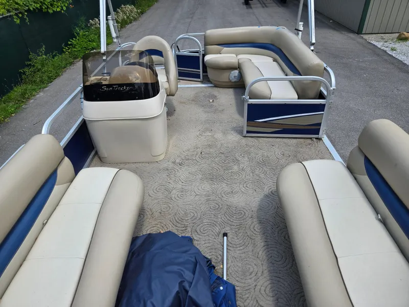 Slide: The Image of 2013 Sun Tracker Party Barge 18 DLX interior with beige and blue seating. - 10