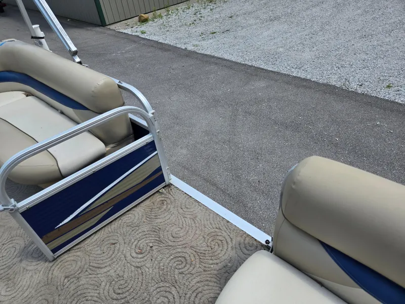 Slide: The Image of 2013 Sun Tracker Party Barge 18 DLX interior with beige and blue seating. - 11