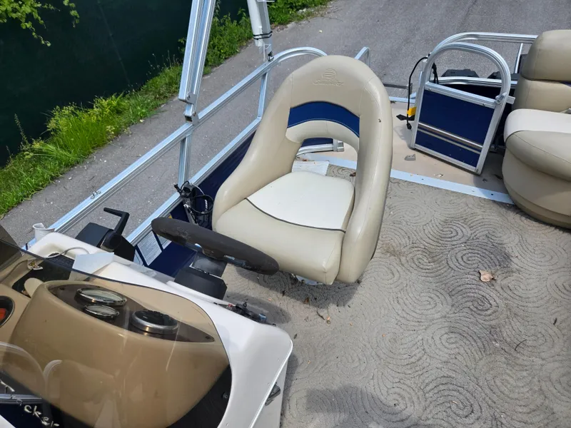 Slide: The Image of 2013 Sun Tracker Party Barge 18 DLX interior with steering wheel and seating. - 12