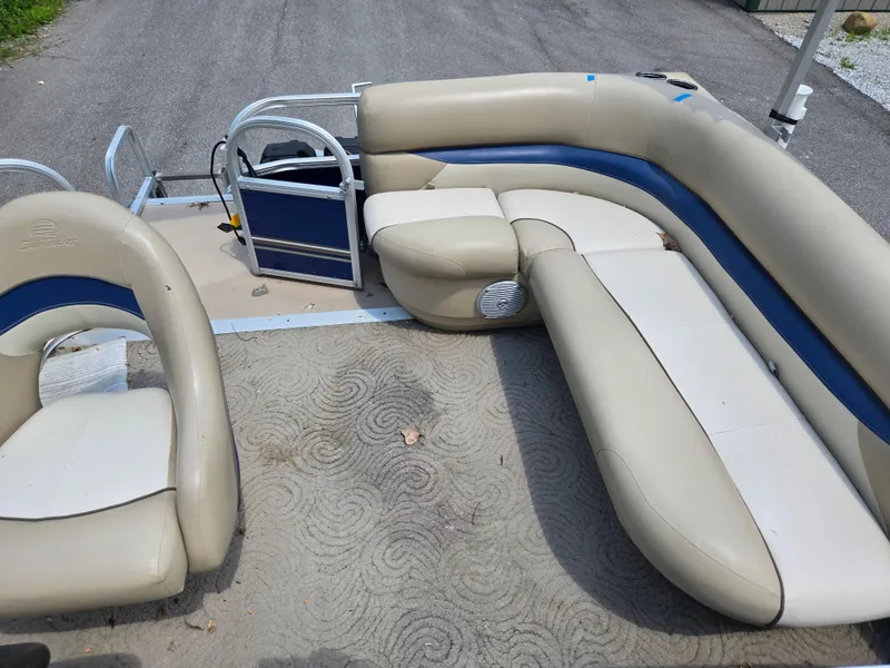 Slide: The Image of 2013 Sun Tracker Party Barge 18 DLX interior with beige and blue seating. - 13